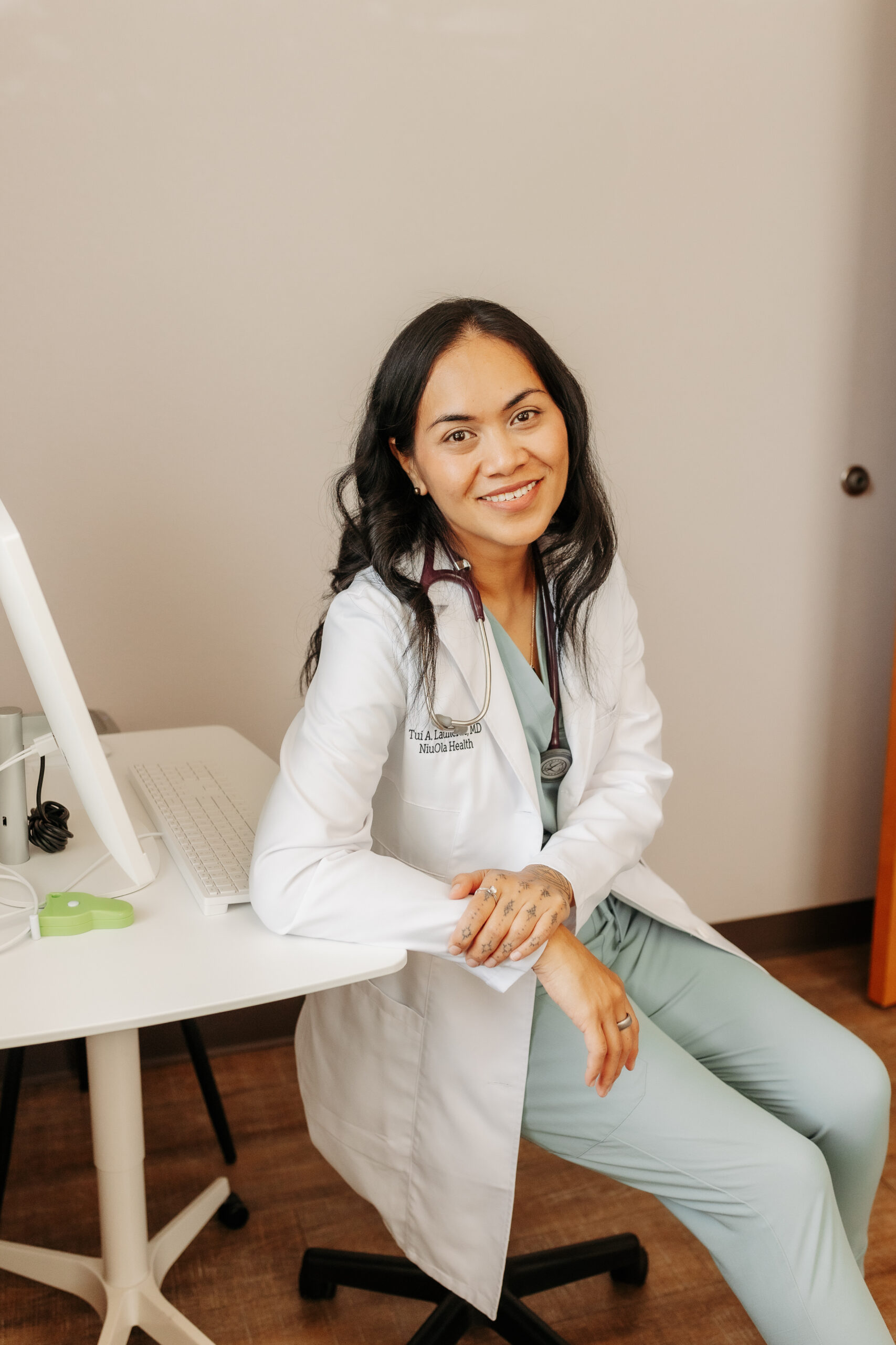 Image of Dr. Tui Lauilefue sitting in a chair in the patient exam room.